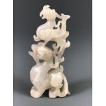 A 19th/early 20thC Chinese carved white jade figure of a phoenix resting on a dragons head, H. 9cm.