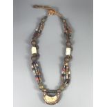 A Tibetan re-strung necklace of small glass, bone and other beads, folded L. 41cm.