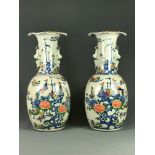 A pair of 19/20th Century hand painted porcelain vases, H. 42cm.