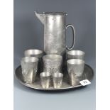 An early 20th Century Chinese Kut Hing, Swatow engraved pewter tray, jug, caddy and six beakers, jug