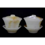 A pair of Chinese 19th century opaline glass tea bowls and covers imitating white jade, H. 8cm, Dia.