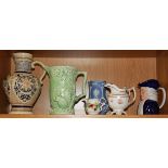 A group of six ceramic jugs along with a collection of Victorian porcelain chamber sticks and