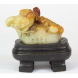 A finely carved Chinese pebble hardstone seal and later stand, overall H. 8cm.