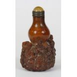 A finely carved Chinese deer antler snuff bottle with gilt and hardstone stopper, H. 8cm.