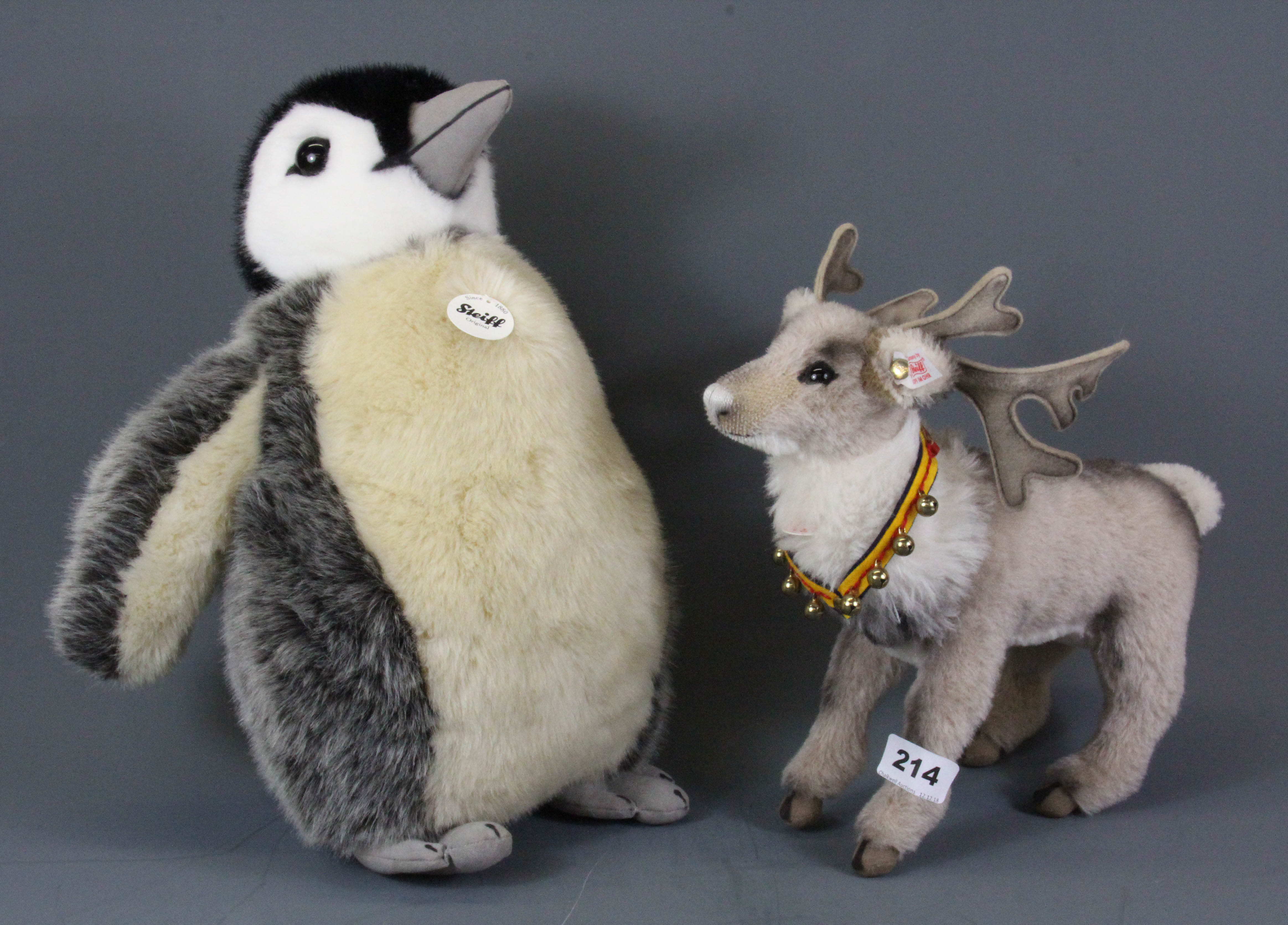 A Steiff penguin, H. 37cm, together with a Steiff reindeer.