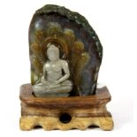 A superb Chinese carved mixed colour jade/ hardstone devotional figure of the Buddha seated with