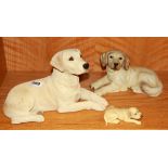 A signed sandcast figure of a golden Labrador together with a figure of a golden retriever and a