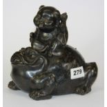 A Chinese cast bronze figure of Chan the three legged toad with a child on its back, H. 18cm.