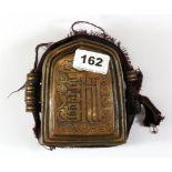 A Tibetan hammered copper Ga'u containing a quantity of black ink scriptures, H. 12cm.