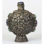 A Tibetan hammered white metal turquoise and lapis snuff bottle, H. 9.5cm. Prov. Penny collection,