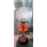 A Victorian pedestal oil lamp with ribbed pink glass reservoir and a duplex burner system with acid