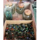 A collection of glass marbles, of varying size and colour.