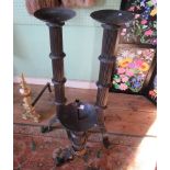 A pair of blacksmith made pricket alter candlesticks and a corresponding blacksmith made table lamp.