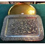 An Indo Moorish circular beaten brass table top tray and a rectangular punch worked,