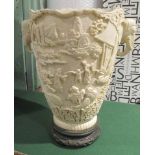 An ivory effect composition elephant headed vase, decorated with relief scenes of Chinese life,