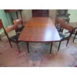 A 1960's vintage teakwood dining group, comprising four chairs and a shaped extending dining table.