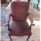 A George III-style library open armchair, with serpentine seat, raised on square fluted supports.