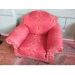 A deep seated stuff-over upholstered easy chair with rollover arms and back.