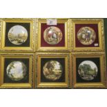 A collection of six gilt framed miniature porcelain pot lids, decorated with artistic scenes,