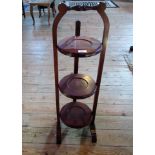 An Edwardian-style mahogany three tier folding cake stand.