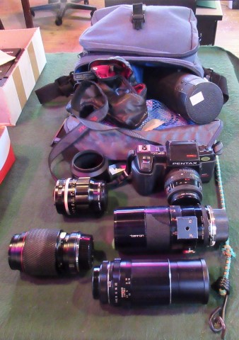 A Pentax SFXN SLR camera, together with other photographic accessories.