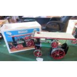 A boxed Mamod steam tractor.