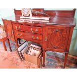 An Edwardian mahogany sideboard, having a low panelled upstand over bow front top,