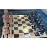 A set of carved soapstone chessmen, together with a conforming board.