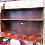 An Edwardian mahogany, boxwood strung set of wall mounting open shelves, with a twin drawer base.