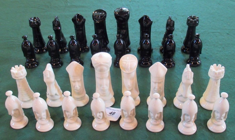 A set of back gloss and white gloss glazed ceramic chessmen.
