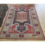 A 20th century caucasian wool rug, woven with bold stepped central geometric medallion,