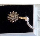 A diamond cluster ring, the claw mounted tiered cluster to a plain 18ct gold shank.