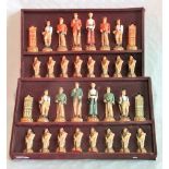 A boxed set of resin moulded chess pieces, of golfing interest, the pawns as caddies,