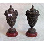 A pair of 19th century, probably French bronze covered urns, each with pineapple finial,
