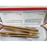 A collection of four gold plated and gilt metal Sheaffer ball point pens.