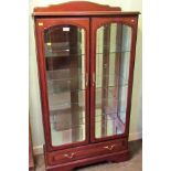 A reproduction display cabinet, having low upstand over a pair of glazed doors and sides,