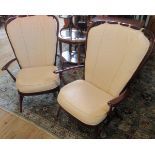 A pair of ercol high back parlour armchairs, each having stick back,