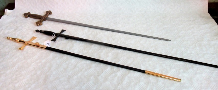 Three reproduction ceremonial swords, two with scabbard.