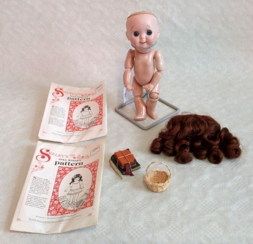 J D Kestner, a porcelain headed doll, mould number 221 with jointed composition body and limbs,