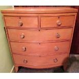 An early 19th century bow front chest of two short and three graduated long drawers,