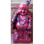 A simulated Cinnabar lacquer model of a smiling Buddha.