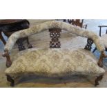 A Victorian walnut framed parlour settee, having a shaped rail, pierced carved splat,