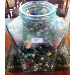 A large quantity of 20th century marbles, contained within a hexagonal glass jar.