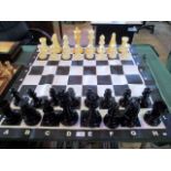 An over-sized set of plastic chessmen of Staunton design,
