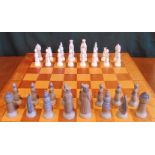 A Lladro porcelain chess set, with well modelled pieces on a boxwood and satinwood board.