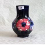 A Walter Moorcroft blue ground ovoid pottery vase,