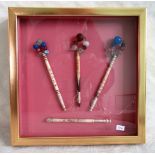 A boxed display of four Bedfordshire-type lace bobbins with spangled decoration.