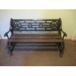 A Victorian cast iron two person garden seat, with fruiting vine end supports,