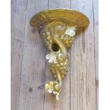 A carved and gilt cornucopia form wall bracket.