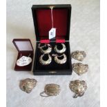 A cased set of four silver wine labels, together with another set of four silver wine labels,